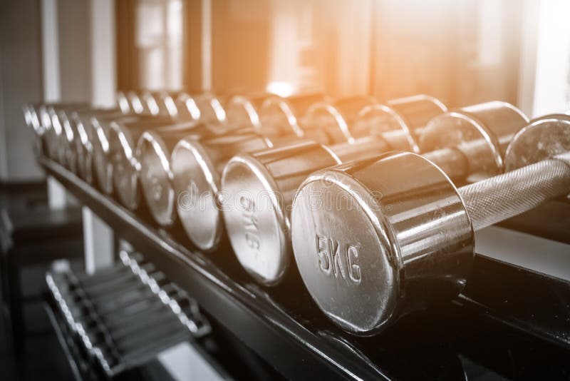 Σειρές 5KG των αλτήρων στη γυμναστική με το μονοχρωματικό τόνο χρώματος στοκ εικόνα με δικαίωμα ελεύθερης χρήσης Σειρές 5KG των αλτήρων στη γυμναστική με το μονοχρωματικό τόνο χρώματος στοκ εικόνα με δικαίωμα ελεύθερης χρήσης