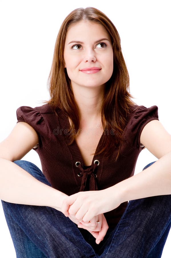 A young woman sitting on floor thinking and looking up. A young woman sitting on floor thinking and looking up