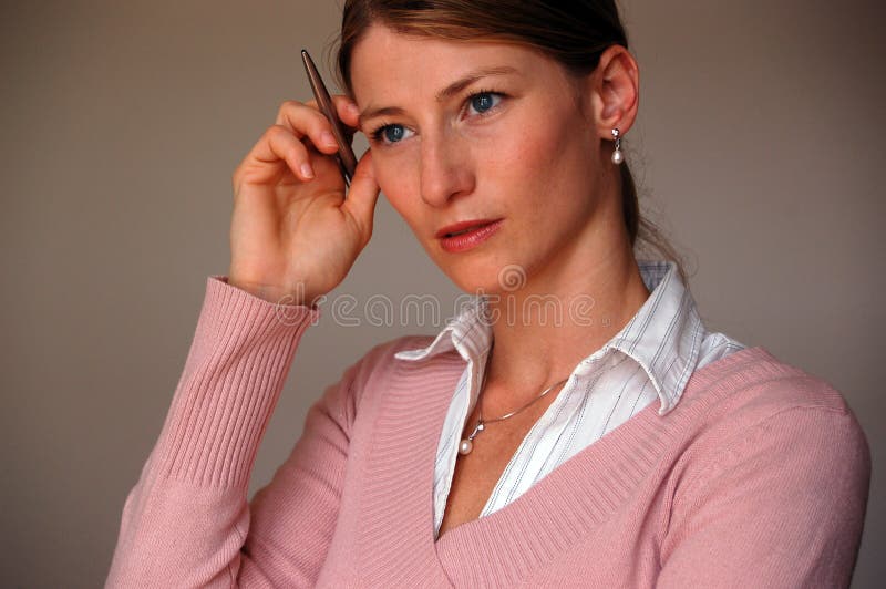 Beautyful business woman holding pen and thinking. Beautyful business woman holding pen and thinking