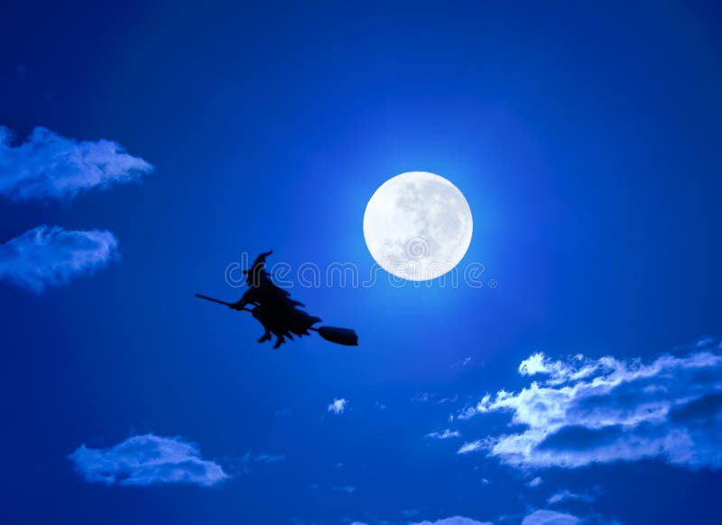 A Halloween witch flying on a broom in a full moon sky. A Halloween witch flying on a broom in a full moon sky