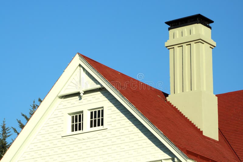 Chimney,side view and roofing of a historical building against a blue sky. Chimney,side view and roofing of a historical building against a blue sky.