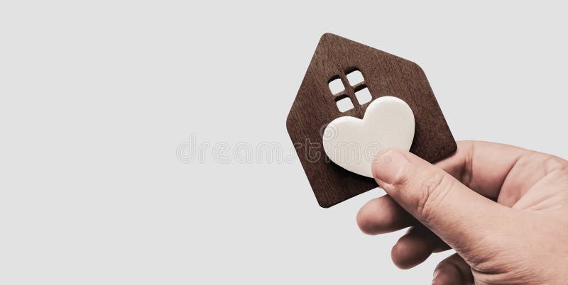 House full of love and care. Hand holding a house with a heart symbol. Happiness and family relationships. Home maintenance concept. House full of love and care. Hand holding a house with a heart symbol. Happiness and family relationships. Home maintenance concept