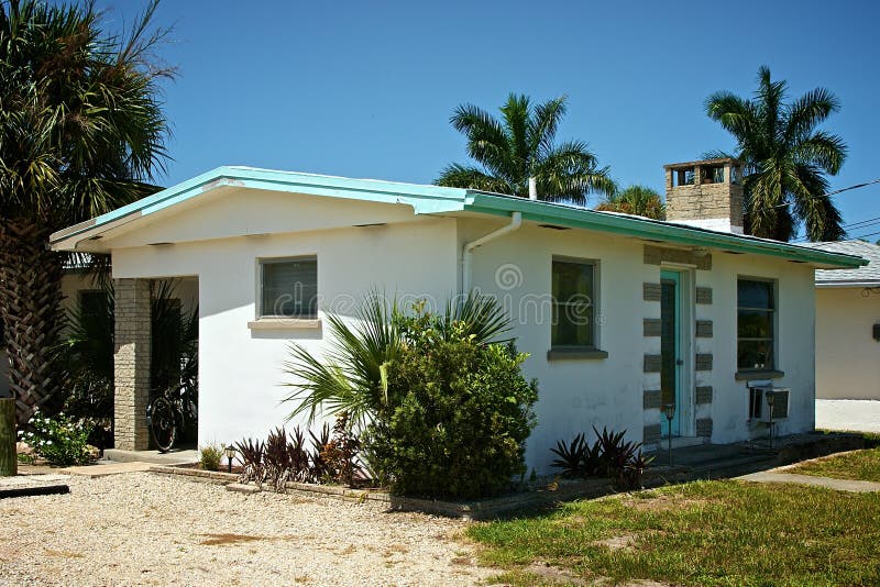 Old small cement florida home from the 1950's with palm trees. Old small cement florida home from the 1950's with palm trees