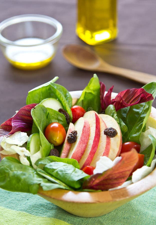 Apple,raisin and spinach salad in a bowl. Apple,raisin and spinach salad in a bowl