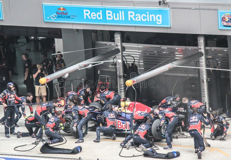 Red Bull Formula 1 Racing Team in midst of a Pit Stop displaying fantastic teamwork. Red Bull Formula 1 Racing Team in midst of a Pit Stop displaying fantastic teamwork.