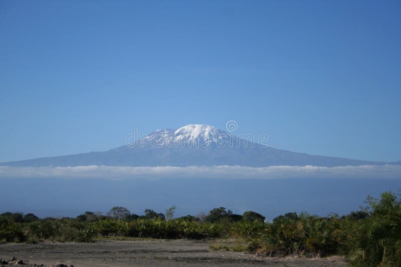 The south face of Kilimanjaro Mountain - The Roof of Africa in a beautiful sunny day. Taken from Chem Chemi Maji Moto, Kilimanjaro Region, Tanzania. The south face of Kilimanjaro Mountain - The Roof of Africa in a beautiful sunny day. Taken from Chem Chemi Maji Moto, Kilimanjaro Region, Tanzania.