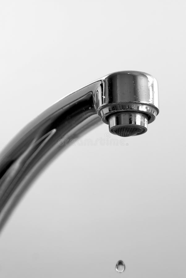 Dripping long necked faucet with water drops stopped in motion. Dripping long necked faucet with water drops stopped in motion