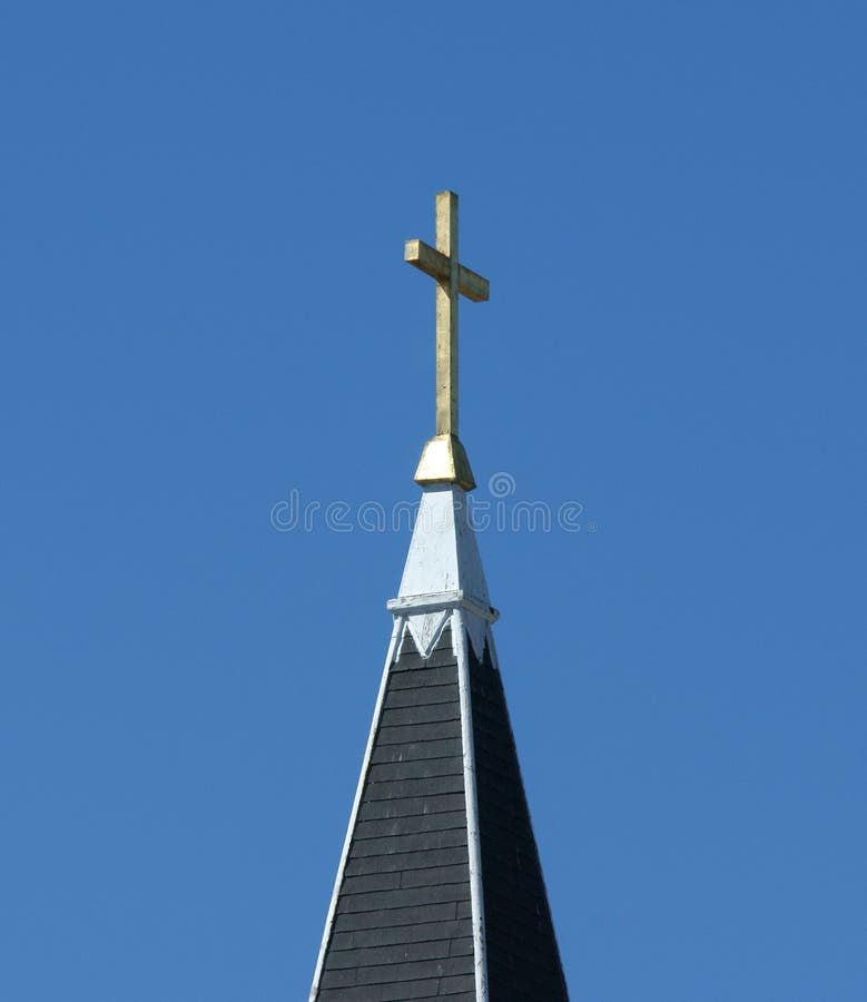 A very simple wooden cross atop a painted church steeple. A very simple wooden cross atop a painted church steeple.