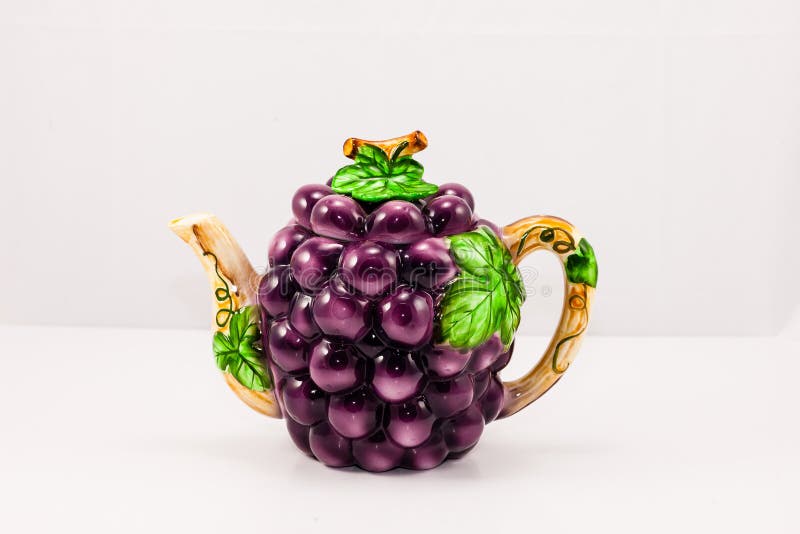 A set of decorative ceramic items in a grape motif. A set of decorative ceramic items in a grape motif.