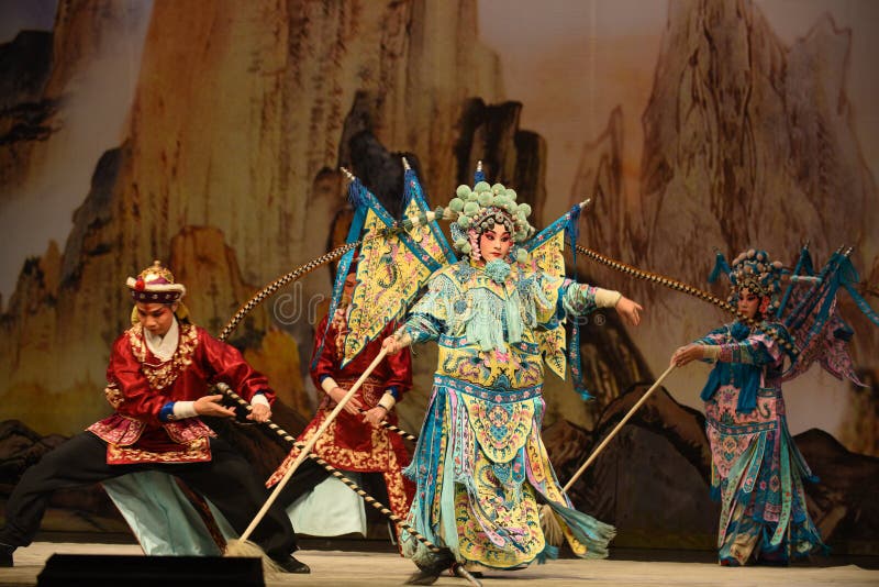 This opera tells a patriotic story how does an old woman of a hundred years old go out for a battle with the twelve women generals of Yang family herself. During the period of Renzong in Song Dynasty, the king of Western Xia invaded its border region, the Song Dynasty’s supreme commander Yang Zongbao fought against the enemies bravely with his army, but unfortunately, he died in the battle by an arrow shot from hiding. Meanwhile, She Taijun of one hundred years old in Yang family was giving a banquet to celebrate her grandson Zongbao’s fiftieth birthday. Everyone in the family was grieved deeply when the tragic news came. When She Taijun heard that the royal court was going to cede territories for peace, she suppressed her grief, refuted the fallacy sternly, and decided to go for the battle herself with the women generals of the Yang family. The great-grandson Yang Wenguang wanted to go with them, his grandmother Princess Chai didn’t let him go in consideration of perpetuating the Yang line. She Taijun told him that he could challenge martial art skills with his mother Mu Guiying to prove whether he can go or not. With his mother’s pretending to fail by his spear skill and the help of Du Jine, the wife of Yang Yansi, Yang Wenguang got his wish. After being defeated utterly, the king of Western Xia intended to capture Yang The Beijing Opera Women Generals of Yang Family was performed in Jiangxi Art Center by The Beijing Opera Troupe of Fujian Province. This opera tells a patriotic story how does an old woman of a hundred years old go out for a battle with the twelve women generals of Yang family herself. During the period of Renzong in Song Dynasty, the king of Western Xia invaded its border region, the Song Dynasty’s supreme commander Yang Zongbao fought against the enemies bravely with his army, but unfortunately, he died in the battle by an arrow shot from hiding. Meanwhile, She Taijun of one hundred years old in Yang family was giving a banquet to celebrate her grandson Zongbao’s fiftieth birthday. Everyone in the family was grieved deeply when the tragic news came. When She Taijun heard that the royal court was going to cede territories for peace, she suppressed her grief, refuted the fallacy sternly, and decided to go for the battle herself with the women generals of the Yang family. The great-grandson Yang Wenguang wanted to go with them, his grandmother Princess Chai didn’t let him go in consideration of perpetuating the Yang line. She Taijun told him that he could challenge martial art skills with his mother Mu Guiying to prove whether he can go or not. With his mother’s pretending to fail by his spear skill and the help of Du Jine, the wife of Yang Yansi, Yang Wenguang got his wish. After being defeated utterly, the king of Western Xia intended to capture Yang The Beijing Opera Women Generals of Yang Family was performed in Jiangxi Art Center by The Beijing Opera Troupe of Fujian Province.