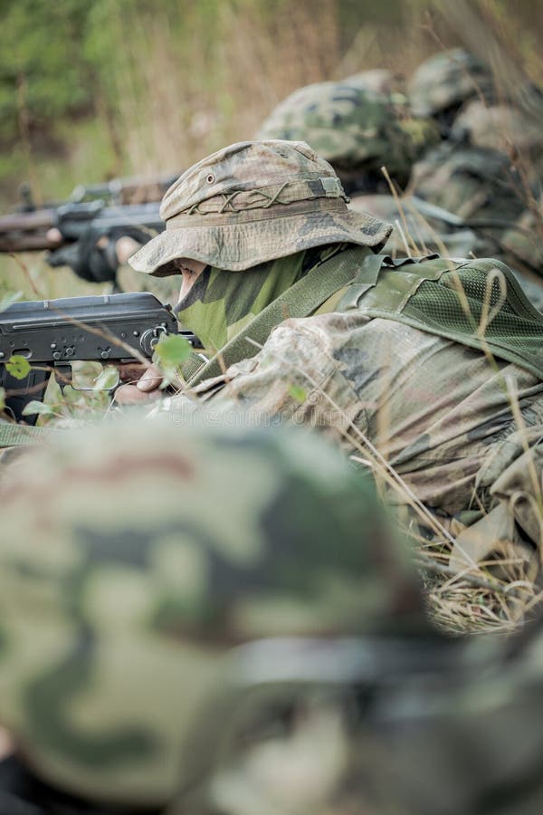 Soldiers in camouflage uniform training in the forest. Soldiers in camouflage uniform training in the forest