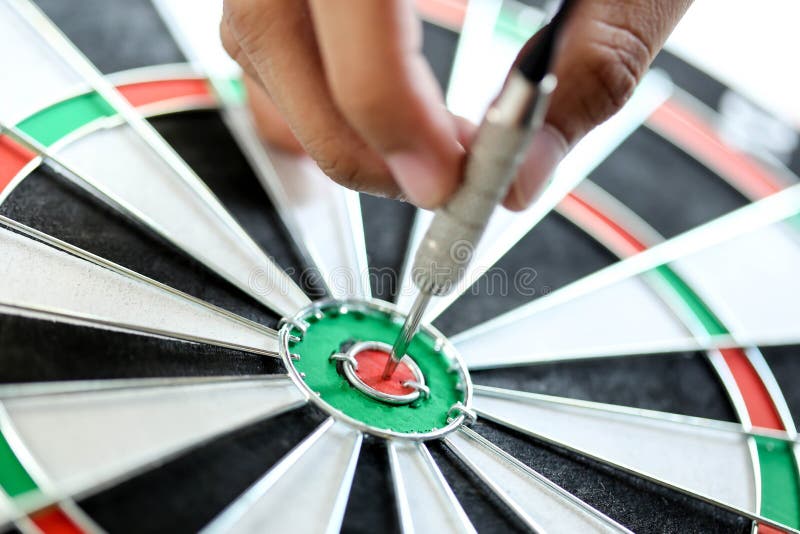 Business strategy planning success target goals, Businessman holding dart push on target. Business strategy planning success target goals, Businessman holding dart push on target.