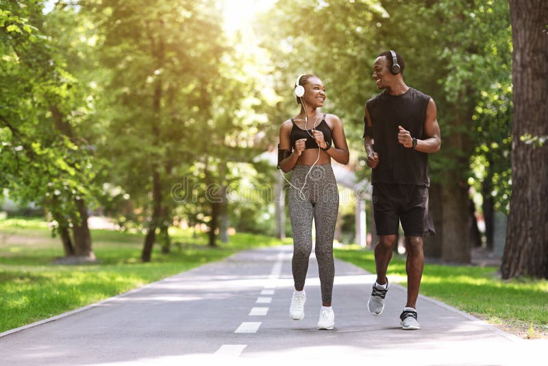 Relationship Goals. Black Couple Jogging Together In Morning Park, Enjoying Training Outdoors, Copy Space. Relationship Goals. Black Couple Jogging Together In Morning Park, Enjoying Training Outdoors, Copy Space