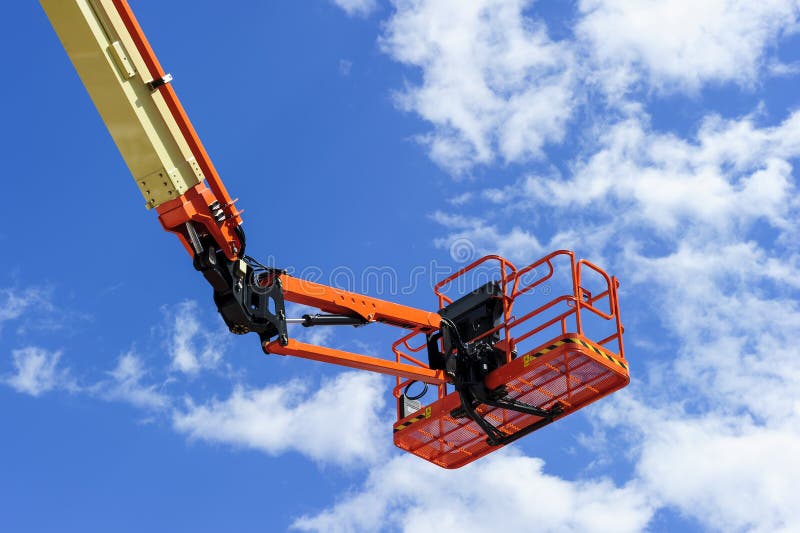 Cherry picker work bucket platform and hydraulic construction cradle of lifting arm painted in orange and beige colors with white clouds and blue sky on background, heavy industry machinery vehicle. Cherry picker work bucket platform and hydraulic construction cradle of lifting arm painted in orange and beige colors with white clouds and blue sky on background, heavy industry machinery vehicle