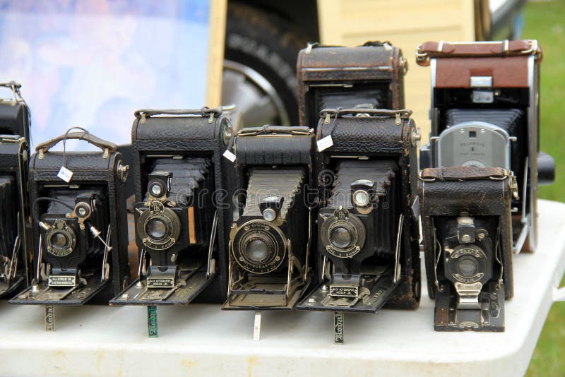 Gorgeous selection of old cameras for sale on vendor`s table, Elephant`s Trunk Flea Market, New Milford, CT, 2017. Gorgeous selection of old cameras for sale on vendor`s table, Elephant`s Trunk Flea Market, New Milford, CT, 2017.