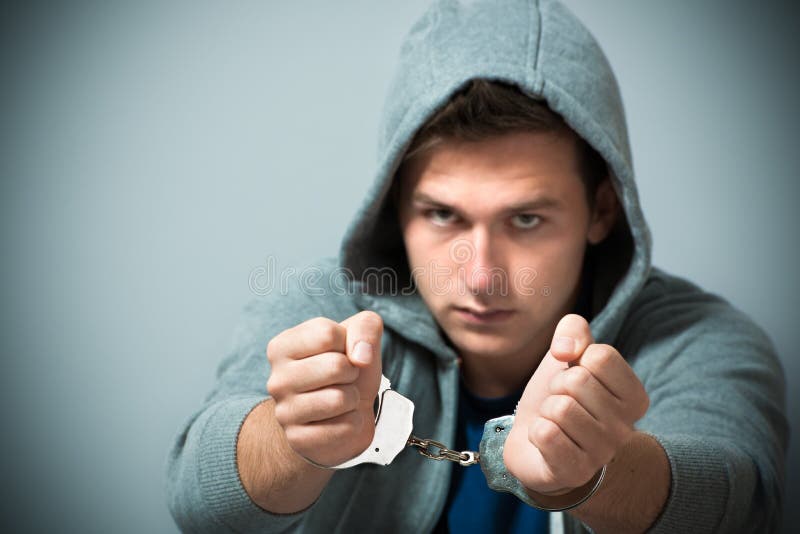 Arrested teenager with handcuffs on his hands. Arrested teenager with handcuffs on his hands