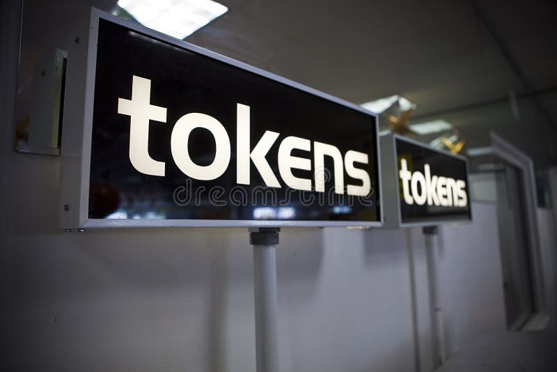 Token machine signs at a carnival midway. Token machine signs at a carnival midway