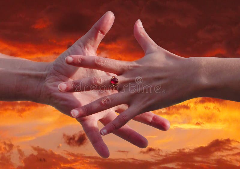 Reaching hands over a sunset background. Reaching hands over a sunset background