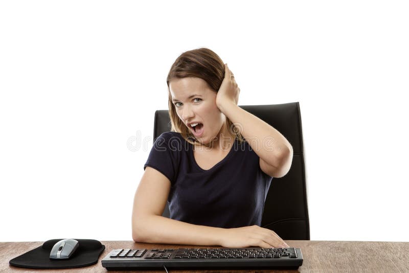 Businesswoman at her desk looking with a hand up to her ear as if someone is shouting at her. Businesswoman at her desk looking with a hand up to her ear as if someone is shouting at her