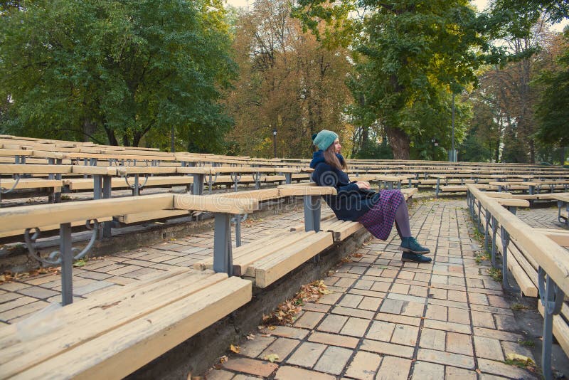 Girl sitting on a park bench. Girl sitting on a park bench