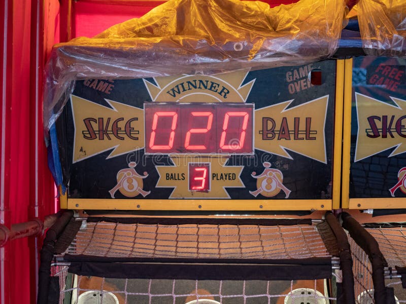 Skee ball arcade game sitting in a tent outdoors with a score of 20. Skee ball arcade game sitting in a tent outdoors with a score of 20