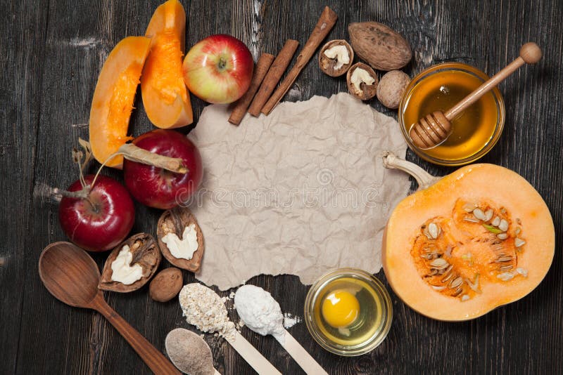 Ingredients for pumpkin and apple pie. Apples, nuts, pumpkin, honey, flour, eggs, oatmeal, sugar on vintage wooden background. Ingredients for pumpkin and apple pie. Apples, nuts, pumpkin, honey, flour, eggs, oatmeal, sugar on vintage wooden background.