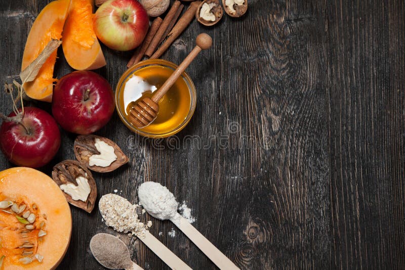 Ingredients for pumpkin and apple pie. Apples, nuts, pumpkin, honey, flour, eggs, oatmeal, sugar on vintage wooden background. Ingredients for pumpkin and apple pie. Apples, nuts, pumpkin, honey, flour, eggs, oatmeal, sugar on vintage wooden background.