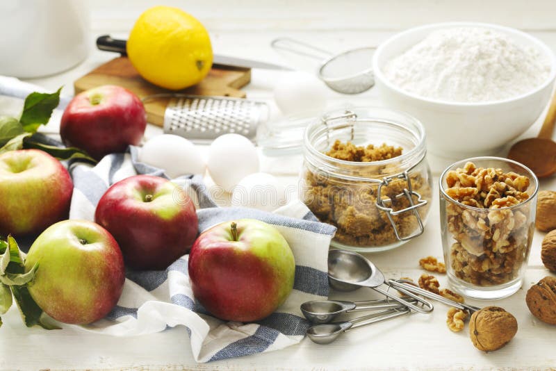 Ingredients for baking apple and nuts pie on wooden table. Ingredients for baking apple and nuts pie on wooden table