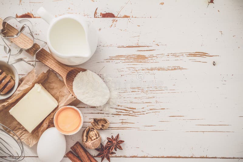 Ingredients for baking - milk butter eggs flour wheat, white wood background, copy space, toned. Ingredients for baking - milk butter eggs flour wheat, white wood background, copy space, toned