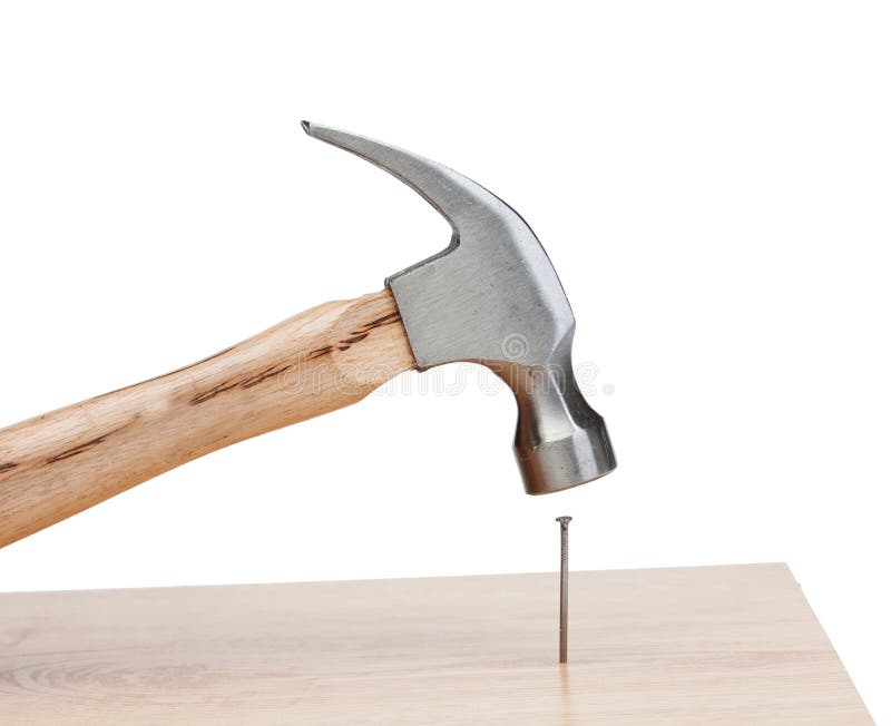 Hammer hitting a nail into a wood isolated on white background. Hammer hitting a nail into a wood isolated on white background