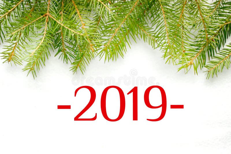 Σχήματα 2019 για ένα άσπρο υπόβαθρο, πλαίσιο των κλάδων έλατου στοκ φωτογραφία με δικαίωμα ελεύθερης χρήσης Σχήματα 2019 για ένα άσπρο υπόβαθρο, πλαίσιο των κλάδων έλατου στοκ φωτογραφία με δικαίωμα ελεύθερης χρήσης