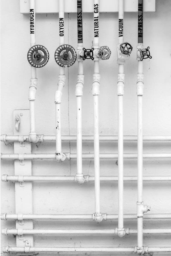 Vintage gas pipes and antique valves in science lab - hydrogen, oxygen, natural gas, vacuum, air. Black and white. Vintage gas pipes and antique valves in science lab - hydrogen, oxygen, natural gas, vacuum, air. Black and white.