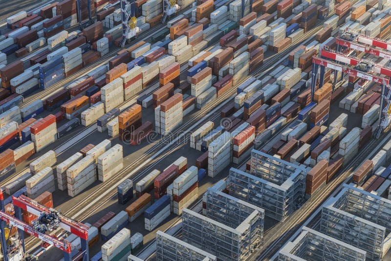 Los Angeles, California, USA - August 16, 2016: Afternoon aerial view of cargo shipping containers stacked on docks. Los Angeles, California, USA - August 16, 2016: Afternoon aerial view of cargo shipping containers stacked on docks.