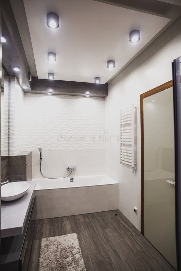 Modern bathroom in white and gray tones with mosaic on wide angle view. Real estate concept. Modern bathroom in white and gray tones with mosaic on wide angle view. Real estate concept.