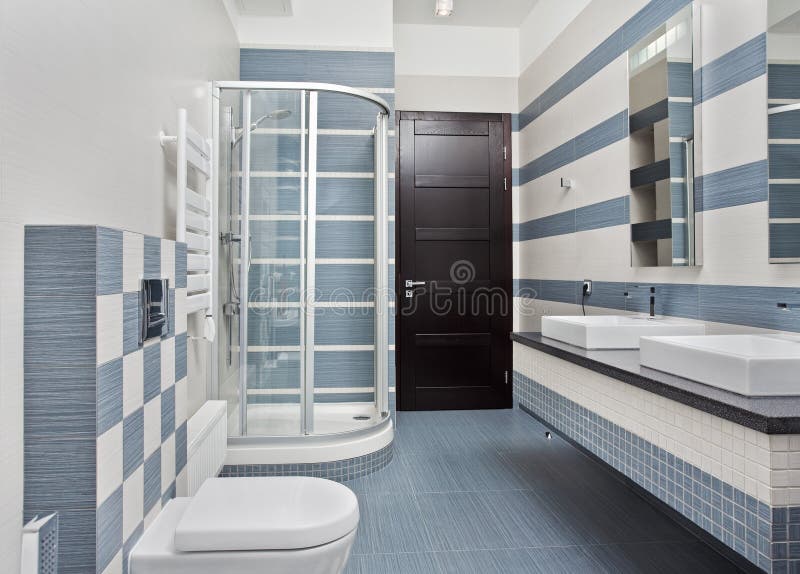 Modern bathroom in blue and gray tones with shower cubicle on wide angle view. Modern bathroom in blue and gray tones with shower cubicle on wide angle view