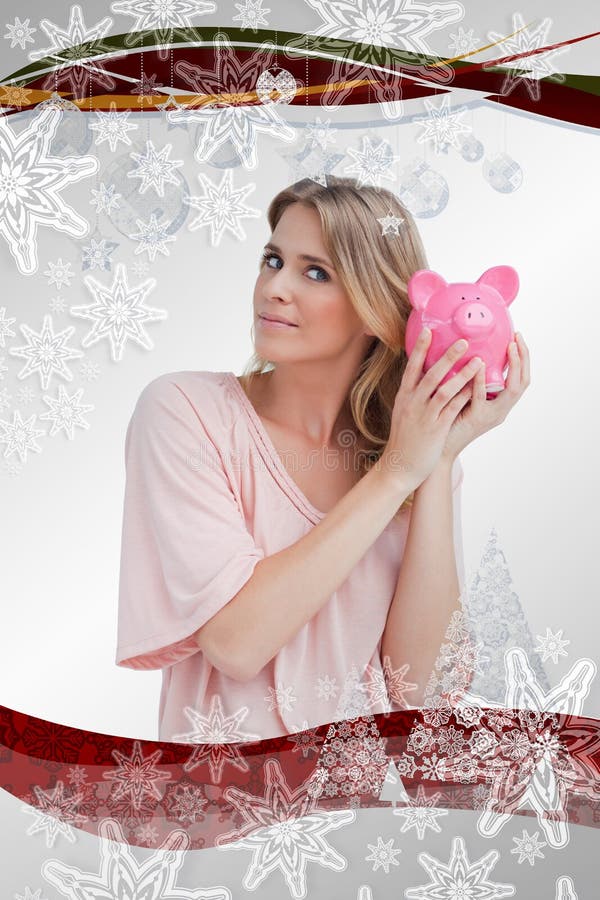 Σύνθετη εικόνα της γυναίκας που κρατά μια piggy τράπεζα μέχρι το κεφάλι της στοκ φωτογραφία Σύνθετη εικόνα της γυναίκας που κρατά μια piggy τράπεζα μέχρι το κεφάλι της στοκ φωτογραφία