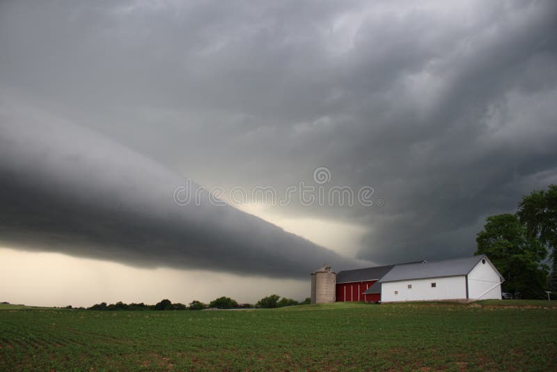 A eerie roll cloud approaches a small midwestern farm. A eerie roll cloud approaches a small midwestern farm.