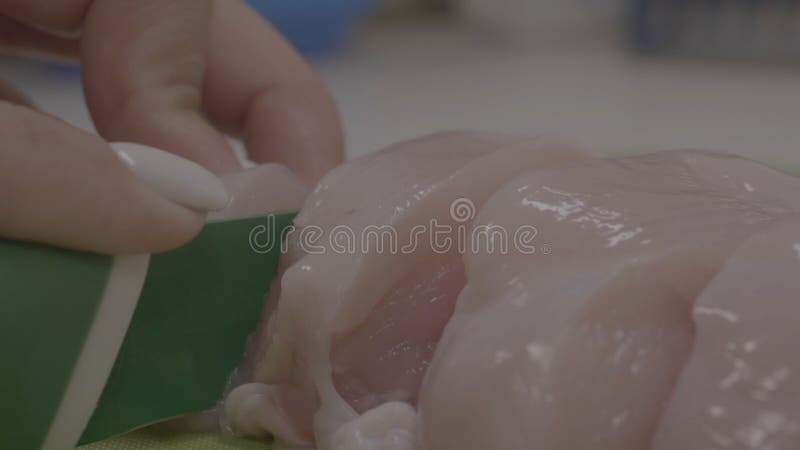 Τέμνον στήθος κοτόπουλου γυναικών στον πίνακα Χέρια του τέμνοντος κρέατος γυναικών στον ξύλινο πίνακα στοκ εικόνες με δικαίωμα ελεύθερης χρήσης Τέμνον στήθος κοτόπουλου γυναικών στον πίνακα Χέρια του τέμνοντος κρέατος γυναικών στον ξύλινο πίνακα στοκ εικόνες με δικαίωμα ελεύθερης χρήσης