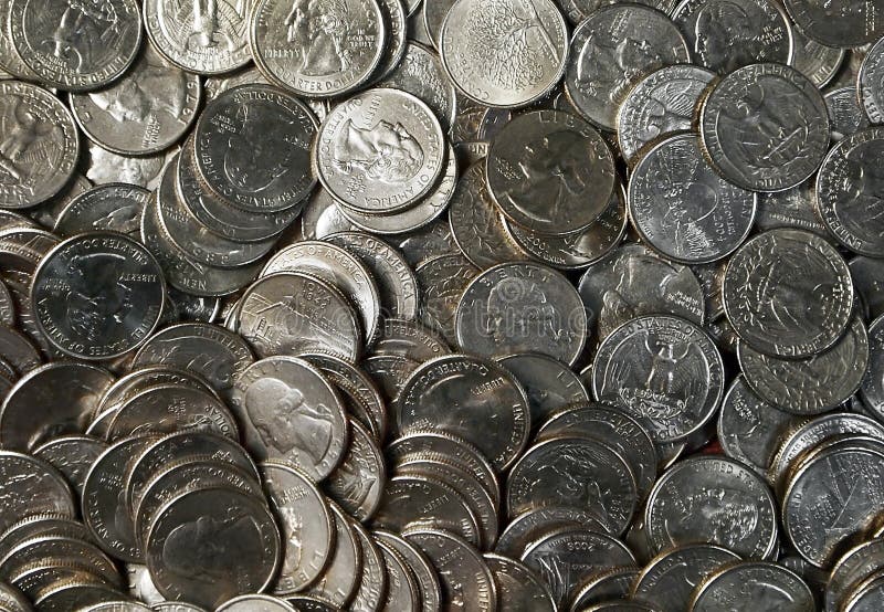 A tray full of American quarters laid out flat for a money themed background image. A tray full of American quarters laid out flat for a money themed background image.