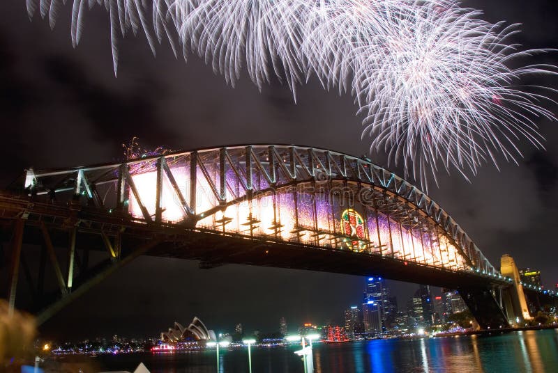 Sparkling New Year Eve nye Fireworks in Sydney Harbour Sky Line At Night, NSW, Australia, Oceania. The Sydney harbour bridge and sydney opera house sparkling in the night. Colourful surface. Night scene, panorama. Sparkling New Year Eve nye Fireworks in Sydney Harbour Sky Line At Night, NSW, Australia, Oceania. The Sydney harbour bridge and sydney opera house sparkling in the night. Colourful surface. Night scene, panorama