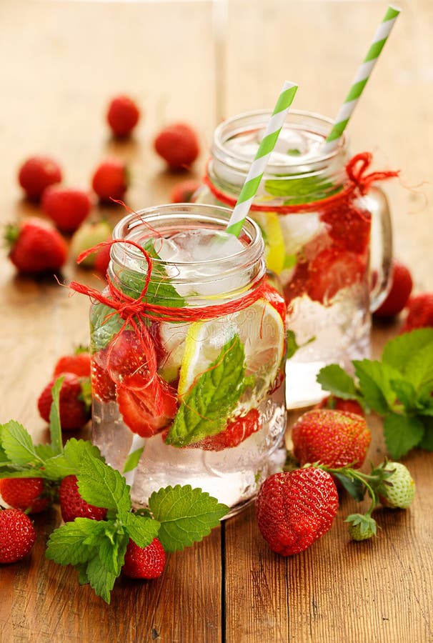 Fruit infused water, refreshing, healthy drink with addition of fresh strawberries, lemon, and mint. Fruit infused water, refreshing, healthy drink with addition of fresh strawberries, lemon, and mint