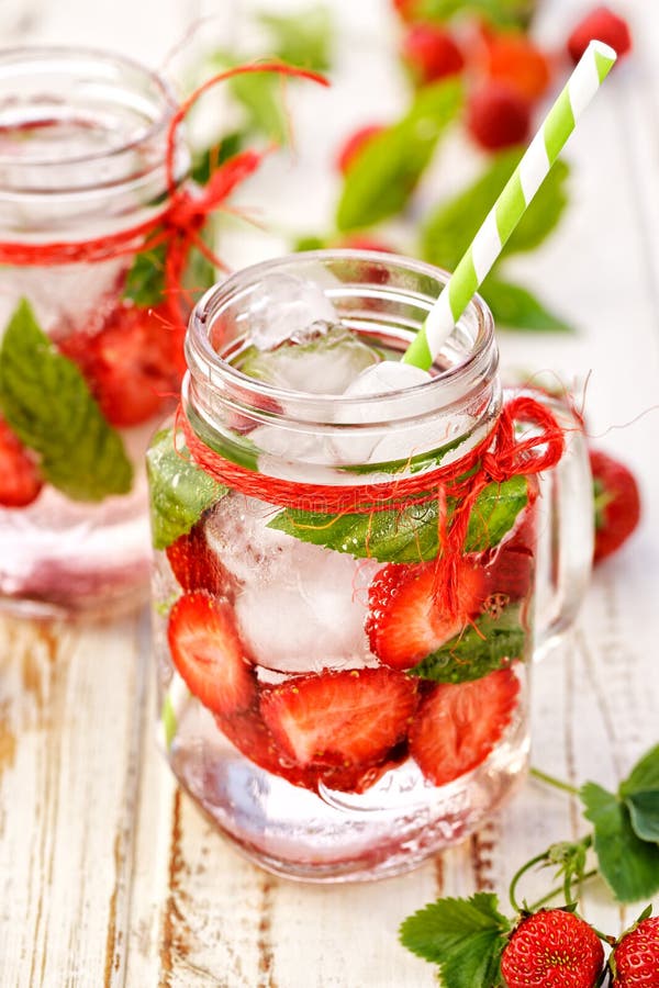 Fruit infused water, refreshing, healthy drink with addition of fresh strawberries and mint. Fruit infused water, refreshing, healthy drink with addition of fresh strawberries and mint