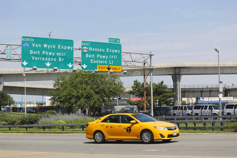 NEW YORK - JULY 10: New York Taxi at Van Wyck Expressway entering JFK International Airport in New York on July 10, 2014. JFK is the busiest international air passenger gateway in the United States. NEW YORK - JULY 10: New York Taxi at Van Wyck Expressway entering JFK International Airport in New York on July 10, 2014. JFK is the busiest international air passenger gateway in the United States