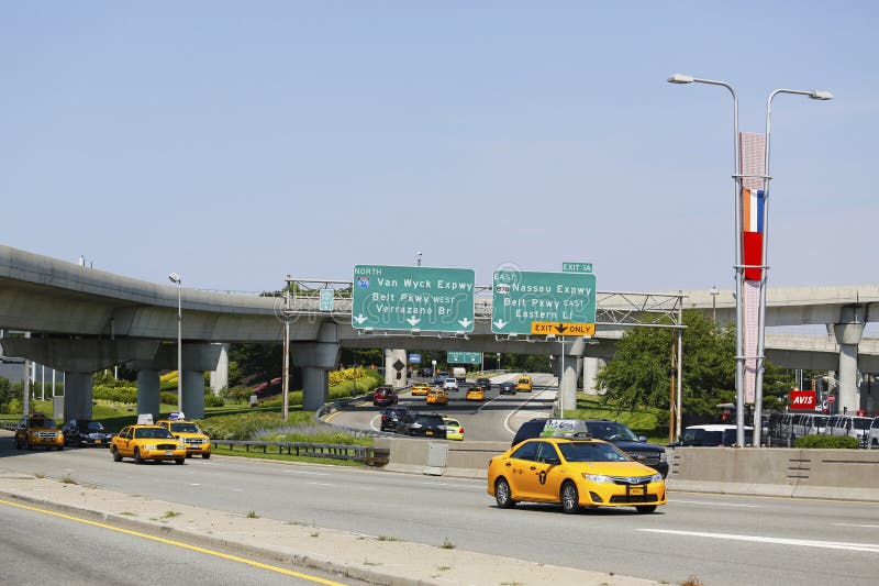 NEW YORK - JULY 10: New York Taxi at Van Wyck Expressway entering JFK International Airport in New York on July 10, 2014. JFK is the busiest international air passenger gateway in the United States. NEW YORK - JULY 10: New York Taxi at Van Wyck Expressway entering JFK International Airport in New York on July 10, 2014. JFK is the busiest international air passenger gateway in the United States