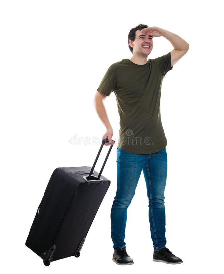 Full length portrait of young man traveler carrying his rolling suitcase holding hand to forehead cover eyes looking away. Guy passenger waiting taxi to airport isolated over white background. Full length portrait of young man traveler carrying his rolling suitcase holding hand to forehead cover eyes looking away. Guy passenger waiting taxi to airport isolated over white background