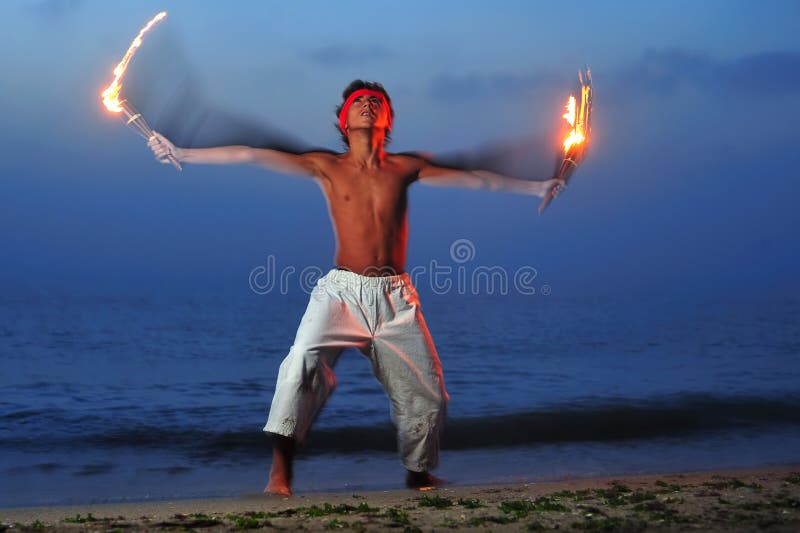 Young boy handling flaming torch in a ritual. Young boy handling flaming torch in a ritual