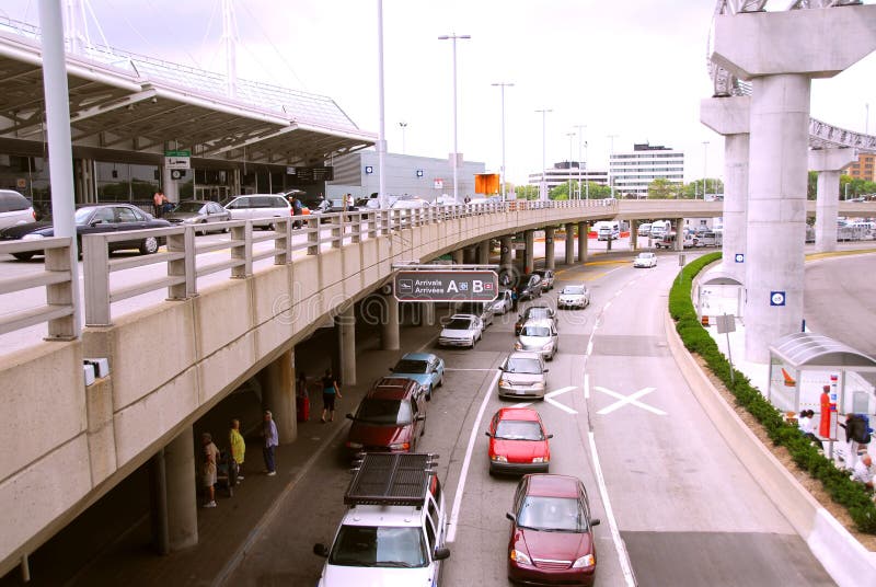 Travelers getting taxis at arrival area of airport. Travelers getting taxis at arrival area of airport