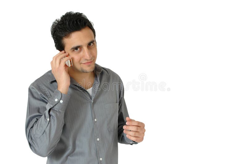 Man of middle eastern descent talks on his cell phone. Man very intent in his conversation on the cell phone. Man isolated on white background. Man of middle eastern descent talks on his cell phone. Man very intent in his conversation on the cell phone. Man isolated on white background