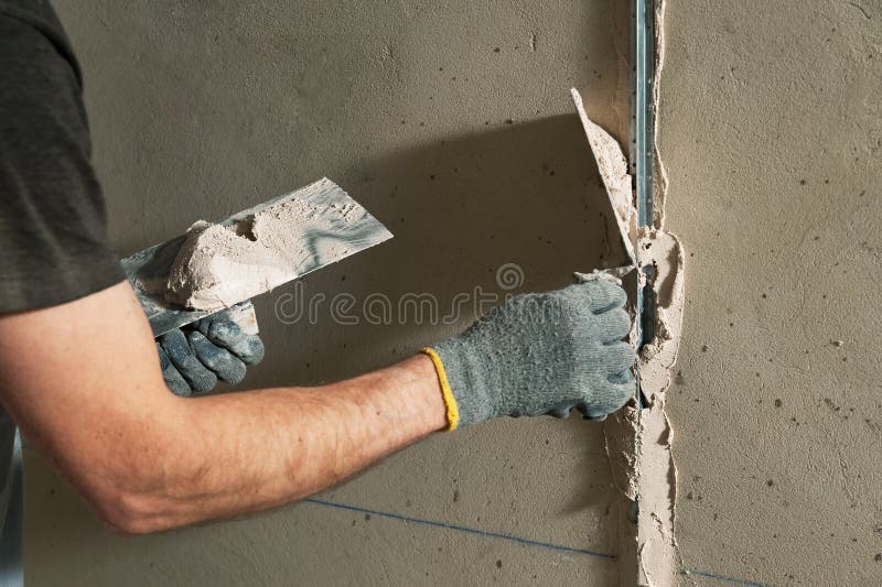 Man fixes a guide to align the walls with stucco in the future. Man fixes a guide to align the walls with stucco in the future