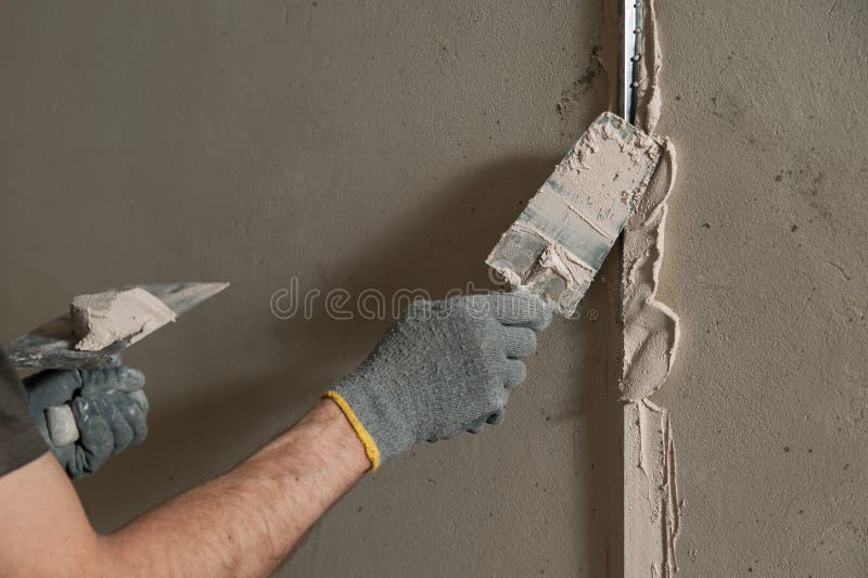 Man fixes a guide to align the walls with stucco in the future. Man fixes a guide to align the walls with stucco in the future